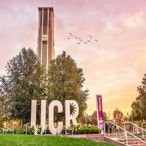 A sunrise image of the UCR monument and bell tower near the Highlander Union Building