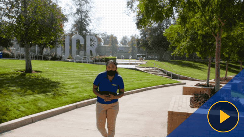 Sarah, a UCR student tour guide, walks along a center-of-campus route